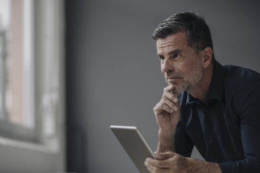 Portrait of mature businessman holding tablet Portrait of mature businessman holding tablet